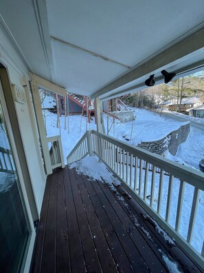Step out onto the covered porch and take in the serene snowy views.