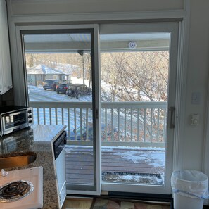 Enjoy a meal in the kitchen, then step out to a balcony with a view of the surrounding landscape.