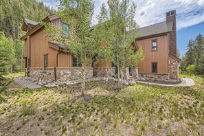 Escape to a serene forest retreat with a covered porch and lush surroundings.
