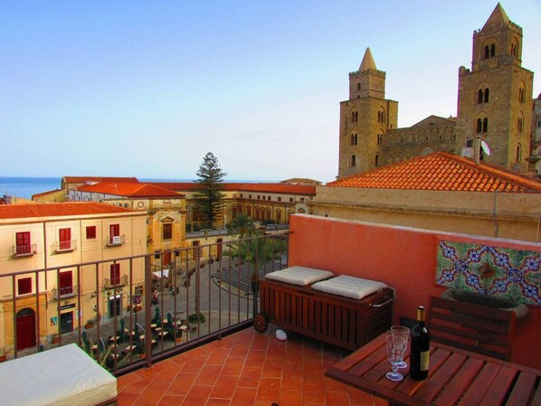 Una terraza con vistas a edificios históricos y al mar.