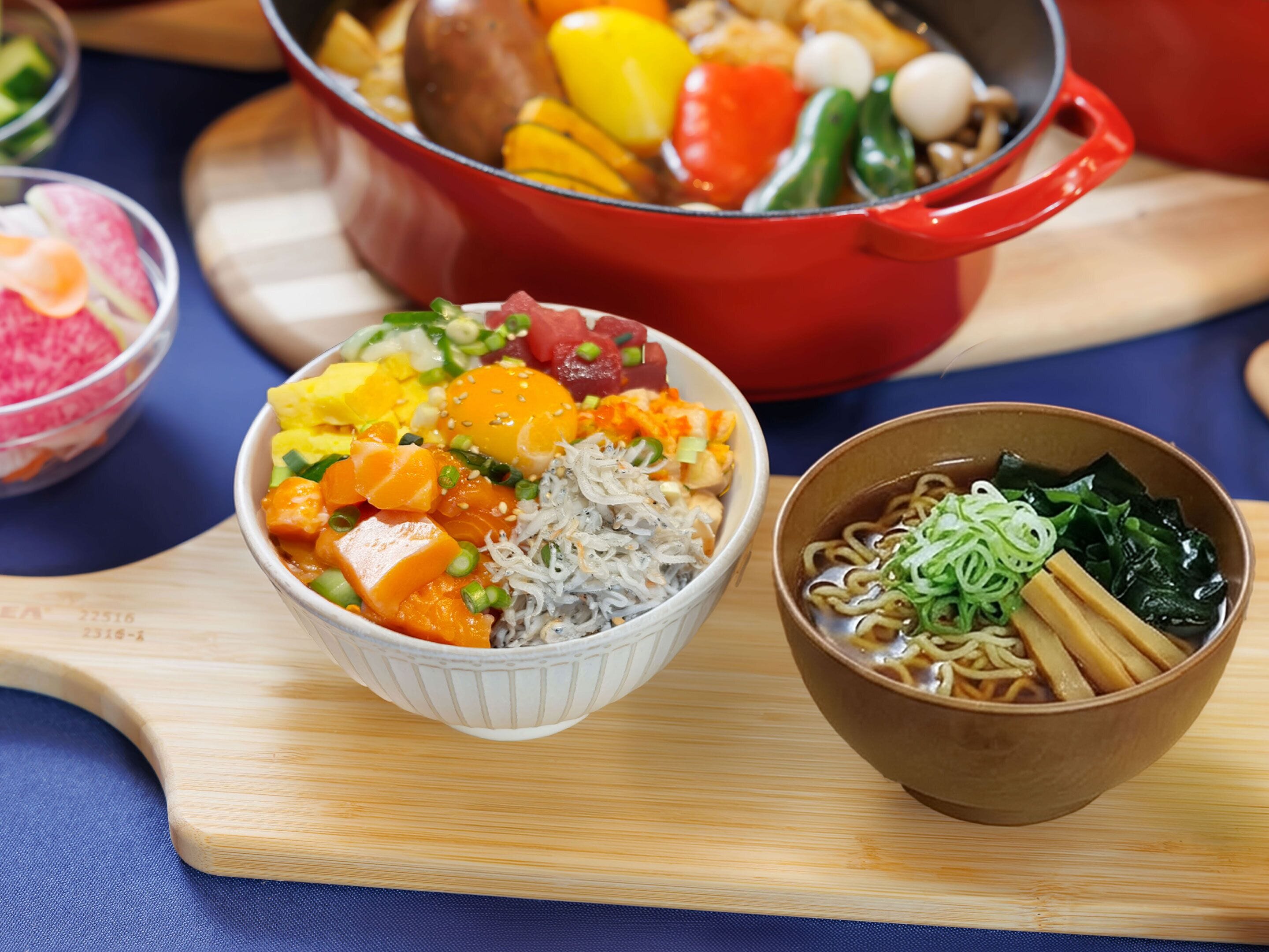 A variety of dishes including a bowl of noodles with vegetables, a bowl of soup with greens, and a pot of mixed vegetables.