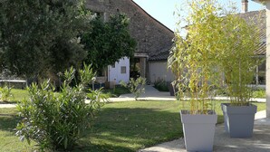 A courtyard with a stone building, potted plants, and a grassy area. - ★★★ SPIRIT BOHÈME CHIC for an inspiring and breathable stay in Haute Gironde ★★★ (CARTELEGUE)