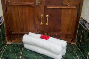 A stylish door with a brass lock and handles, set against a backdrop of elegant flooring.