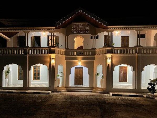 Stunning building with a central entrance, arched windows, and ornate balconies.