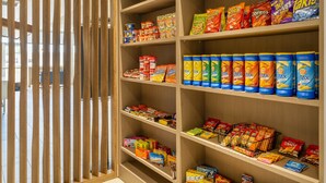 A snack aisle with various packaged snacks and chips. - Holiday Inn Express & Suites Watertown by IHG (Watertown)