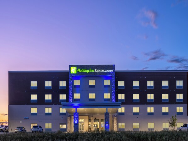 A Holiday Inn Express & Suites building with a modern facade, multiple windows, and a well-lit entrance. - Holiday Inn Express & Suites Watertown by IHG (Watertown)