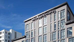 A modern hotel building with a prominent sign reading "Mercure Hotel". - Mercure Auckland Queen Street (Auckland)