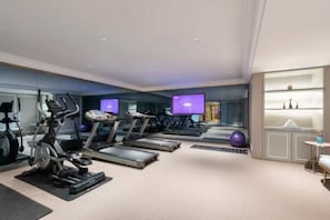 A modern gym with treadmills, stationary bikes, and a mirrored wall. - Mercure Yan'an Downtown (Yan'an)