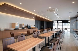 Enjoy meals in this stylish dining area with a long counter and multiple tables.