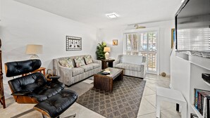 A living room with a sofa, armchairs, a coffee table, and a TV. - Sea Gate Villas 20 2 Bedroom Condo with Outdoor Pool! (Myrtle Beach)