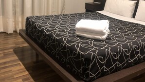 A hotel room with a bed, a nightstand, a lamp, and a window with curtains. - Bagu Buenos Aires (Buenos Aires)