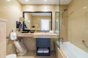 A modern bathroom with a large mirror, a sink, a shower, and a toilet. - Tahiti (Formentera)