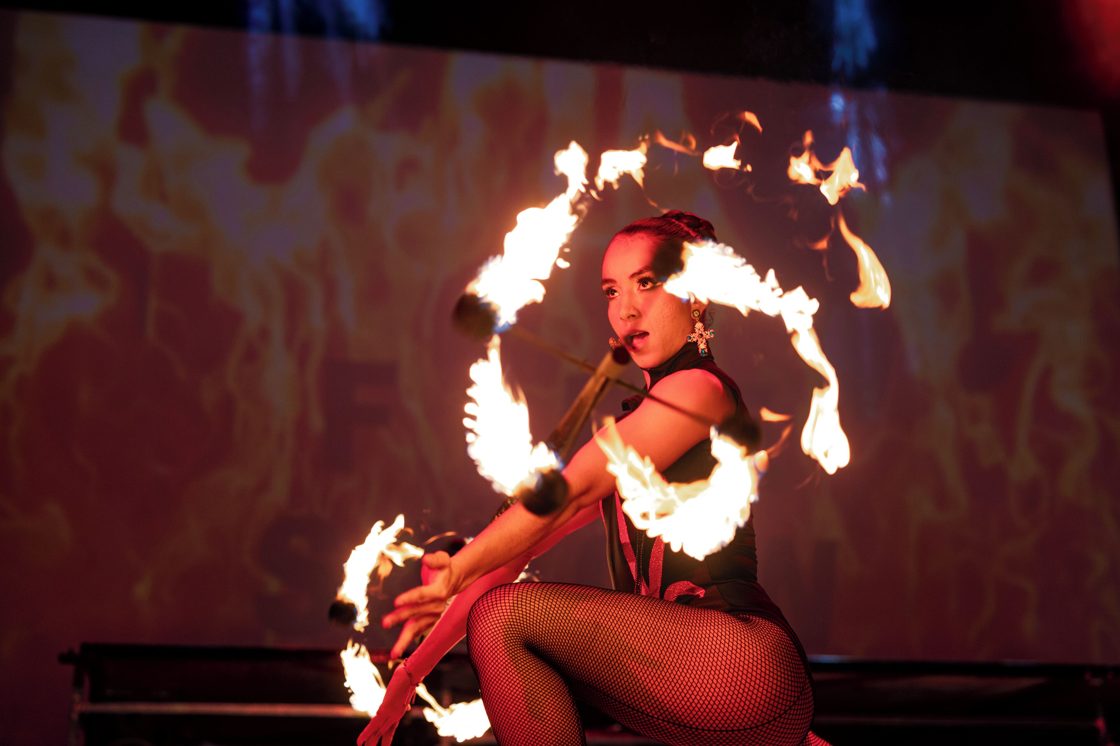 A performer with fire hoops.
