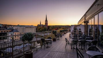 Enjoy a rooftop view of the city from our outdoor dining and relaxation space.