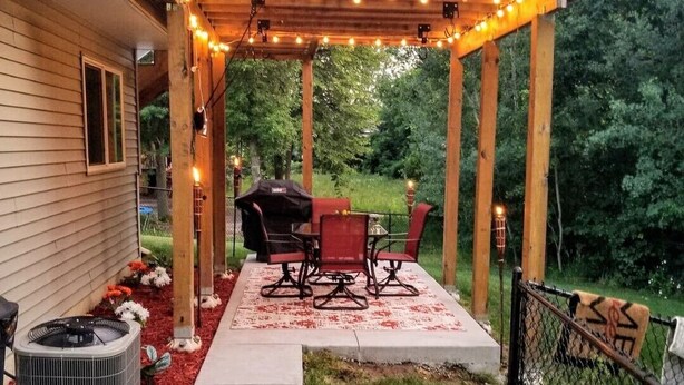 A covered patio with a barbecue setup, outdoor seating, and string lights. - 2 Bedroom Oasis! Mother in-Law Apt Forest Lake, MN (Forest Lake)