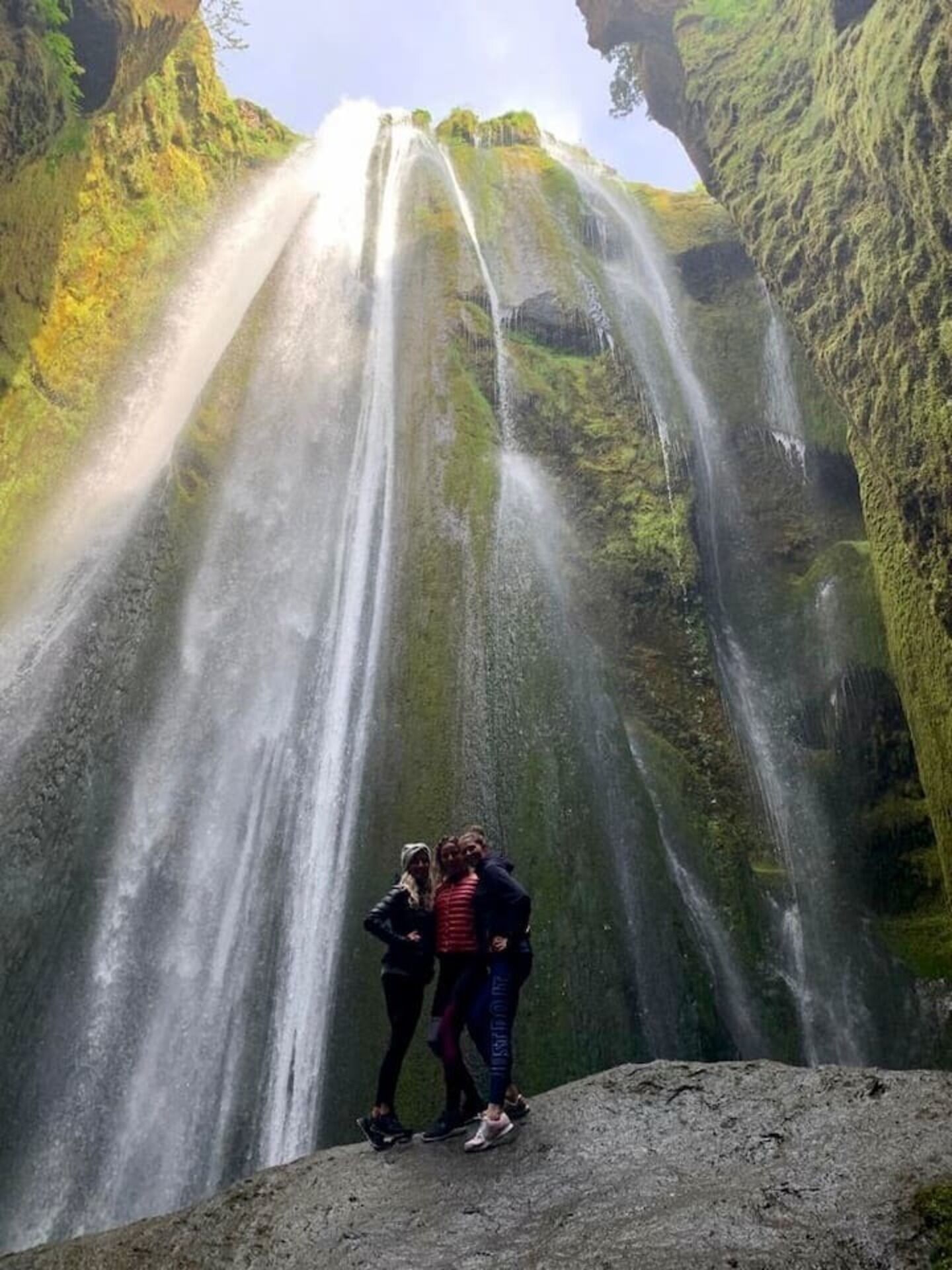 A waterfall with a natural arch formation.