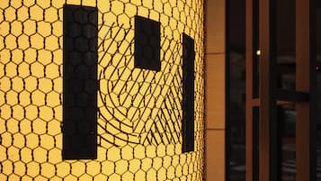 A close-up of a hexagonal patterned wall with two rectangular windows.