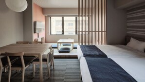 A modern hotel room with a large bed, a dining table with chairs, a TV, and a window with blinds. - MONday Apart Premium GINZA SHINTOMICHO (Tokyo)
