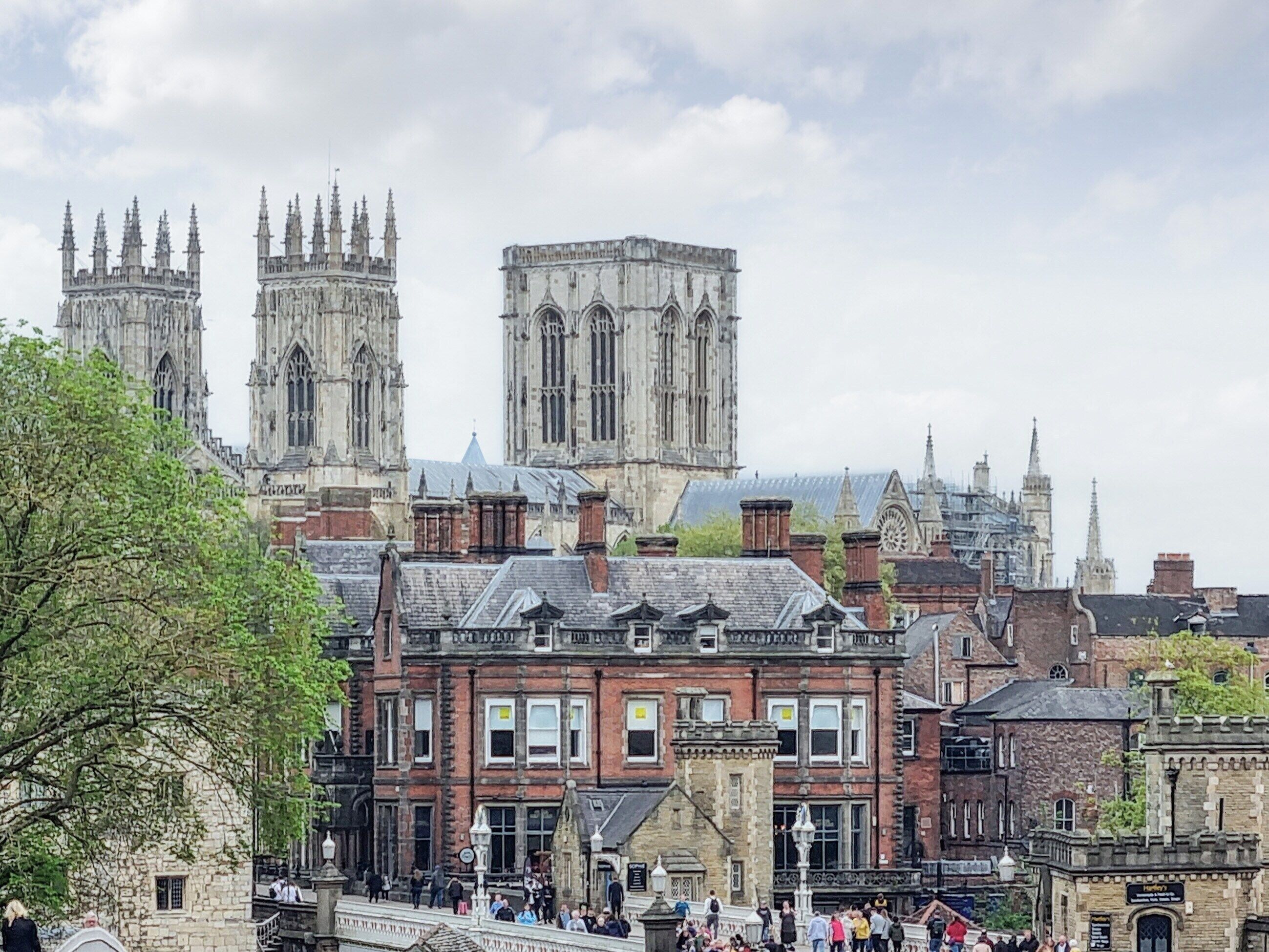 A historic building with Gothic architecture, including pointed arches and a large tower.