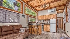 A spacious kitchen with wooden cabinets, a central island, and a built-in oven.
