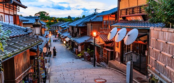 A traditional Japanese street with wooden buildings, tiled roofs, and lanterns. - MIMARU Osaka Shinsaibashi East (Osaka)