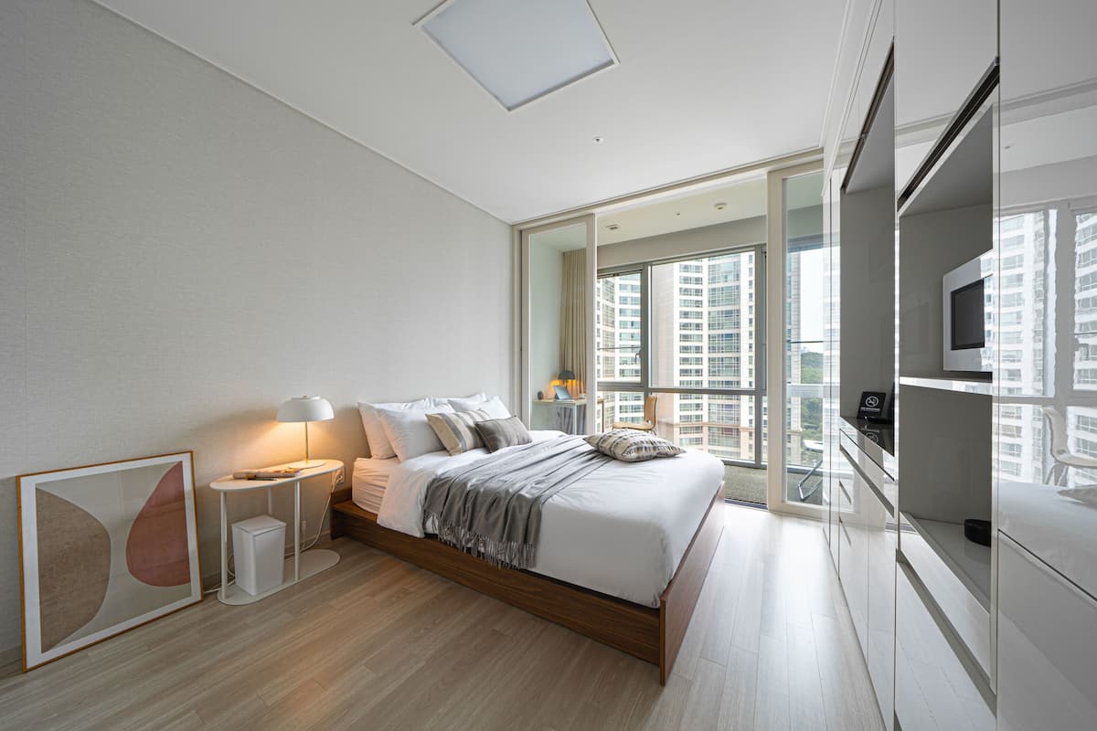 Premium bedding, desk, laptop workspace, blackout curtains