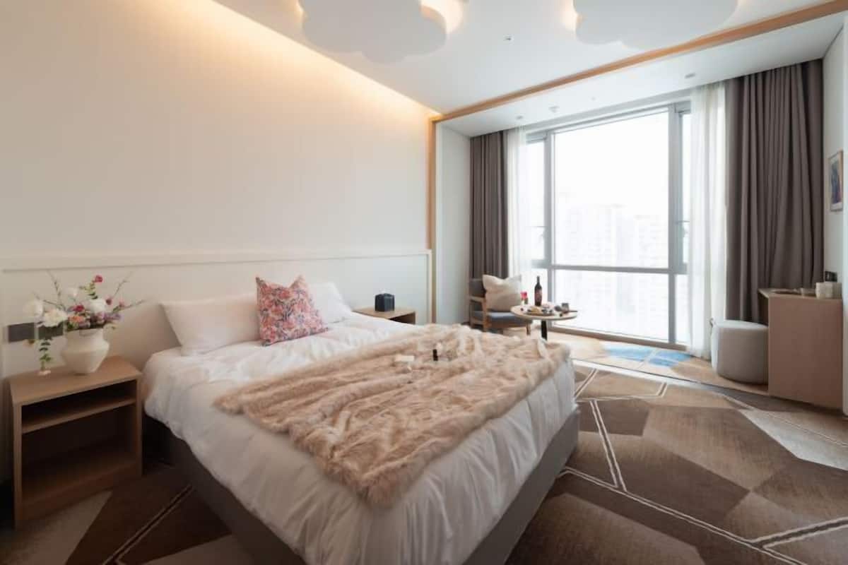 Premium bedding, desk, laptop workspace, blackout curtains