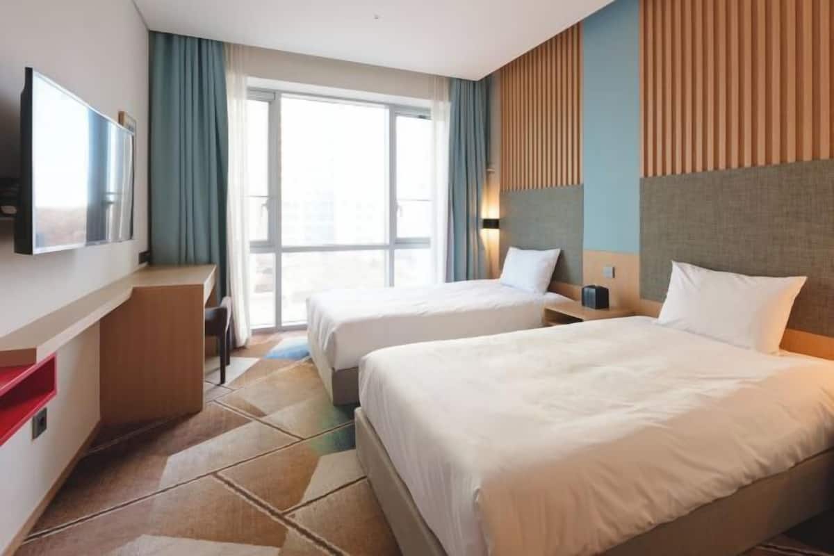 Premium bedding, desk, laptop workspace, blackout curtains
