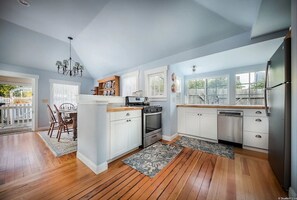 Enjoy cooking in this well-equipped kitchen with a central island, stove, oven, and dishwasher.