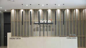 A hotel reception desk with a modern design, featuring a reception area labeled "Front Desk" and "Concierge." - Hotel Arina (Miryang)