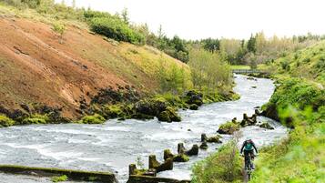 A river with a rocky path alongside it.
