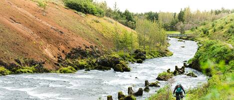 A river with a rocky path alongside it.