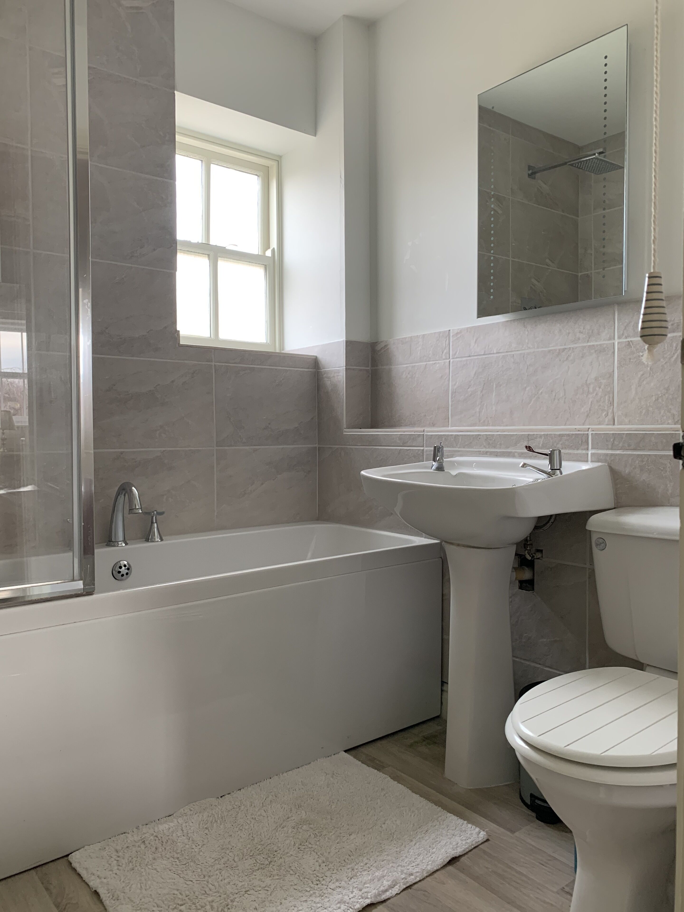 Combined shower/bathtub, towels, soap, toilet paper