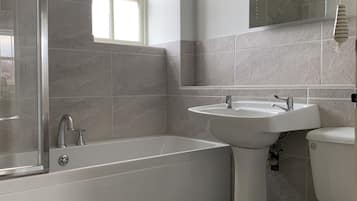 Combined shower/bathtub, towels, soap, toilet paper