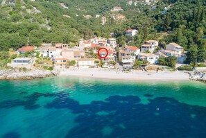 A coastal village with houses along the beach and a no swimming sign in the water. - Georgia - Two Bedroom Apartment, Sleeps 4 (Katavolos)