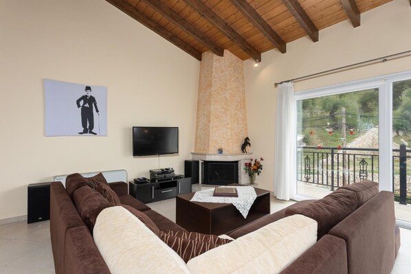 A living room with a fireplace, a television, and a sofa.
