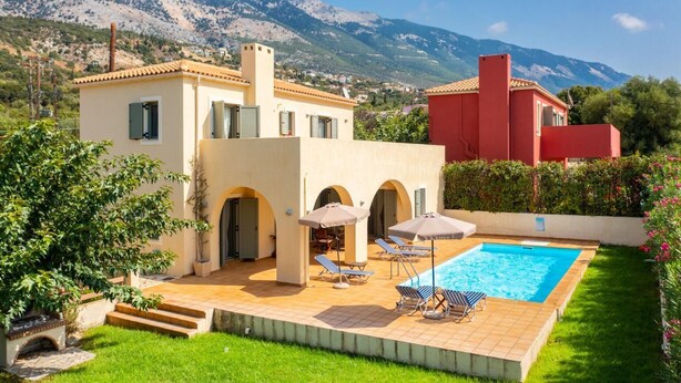 A modern villa with a swimming pool, outdoor seating, and a mountainous backdrop. - Villa Katerina - Three Bedroom Villa, Sleeps 6 (Afrato)