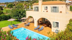 A Mediterranean-style villa with a swimming pool, outdoor seating, and a view of the surrounding hills. - Villa Katerina - Three Bedroom Villa, Sleeps 6 (Afrato)