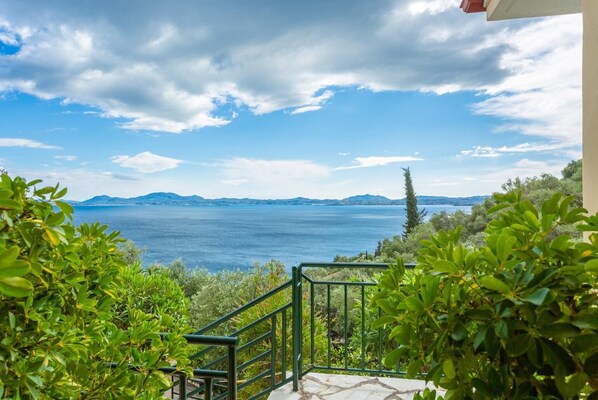 A balcony with a view of a large body of water and distant mountains. - Villa Sofia - Four Bedroom Villa, Sleeps 8 (Corfu)