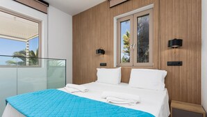 A bedroom with a bed, a window, and a view of palm trees. - Villa Sevos - Two Bedroom Villa, Sleeps 4 (Crete)