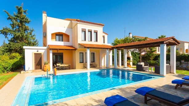 A two-story house with a swimming pool, outdoor seating, and a pergola. - Villa Kefalas Large Private Pool, A/C, WiFi (Apokoronos)