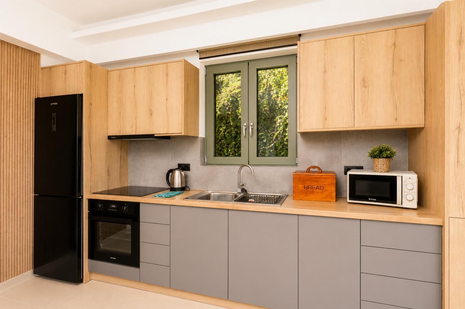A modern kitchen with wooden cabinets, a black refrigerator, a microwave, and a sink.