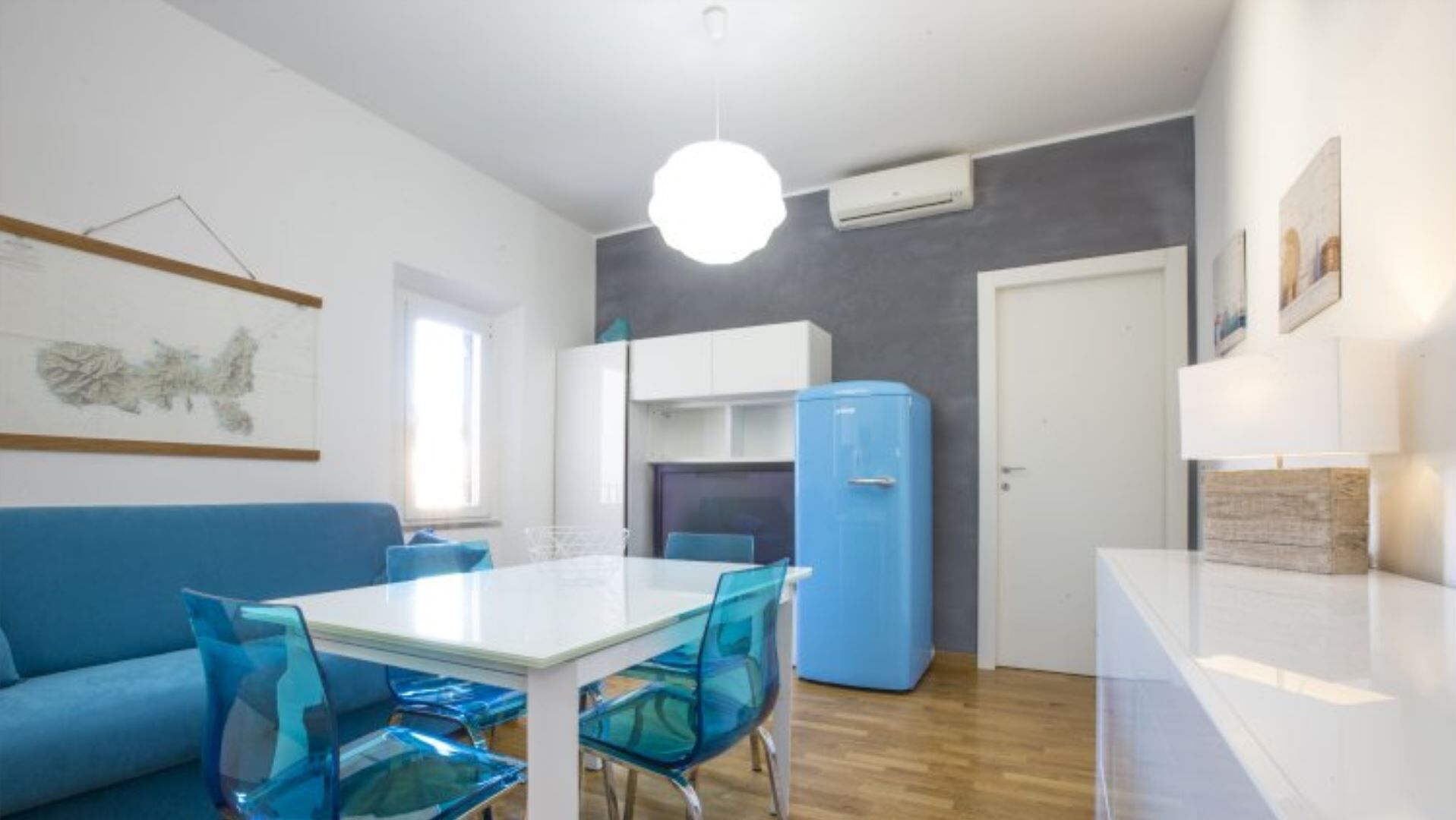 A compact living space with a dining area, a kitchenette, and a seating area.