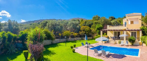 A villa with a swimming pool, outdoor seating, and a view of a hilly landscape. - Villa Mary - Three Bedroom Villa, Sleeps 6 (Crete)