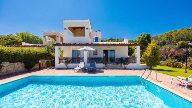 A two-story house with a swimming pool, outdoor seating, and a garden. - Villa Georgia - Three Bedroom Villa, Sleeps 6 (Crete)