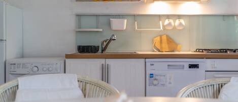 A kitchen with a microwave, stove, and dishwasher.