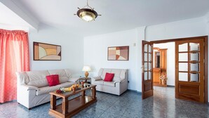 A living room with two sofas, a coffee table, and a chandelier. - Villa Ramos Uno - Four Bedroom Villa, Sleeps 8 (Puerto Calero)