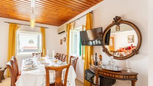A dining room with a wooden ceiling, a TV mounted on the wall, and a large mirror. - Villa Constantinos - Three Bedroom Villa, Sleeps 6 (Agia Marina Chrysochous)