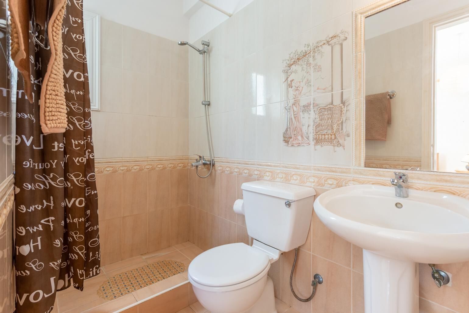 Ein Badezimmer mit Dusche, Toilette und Waschbecken.