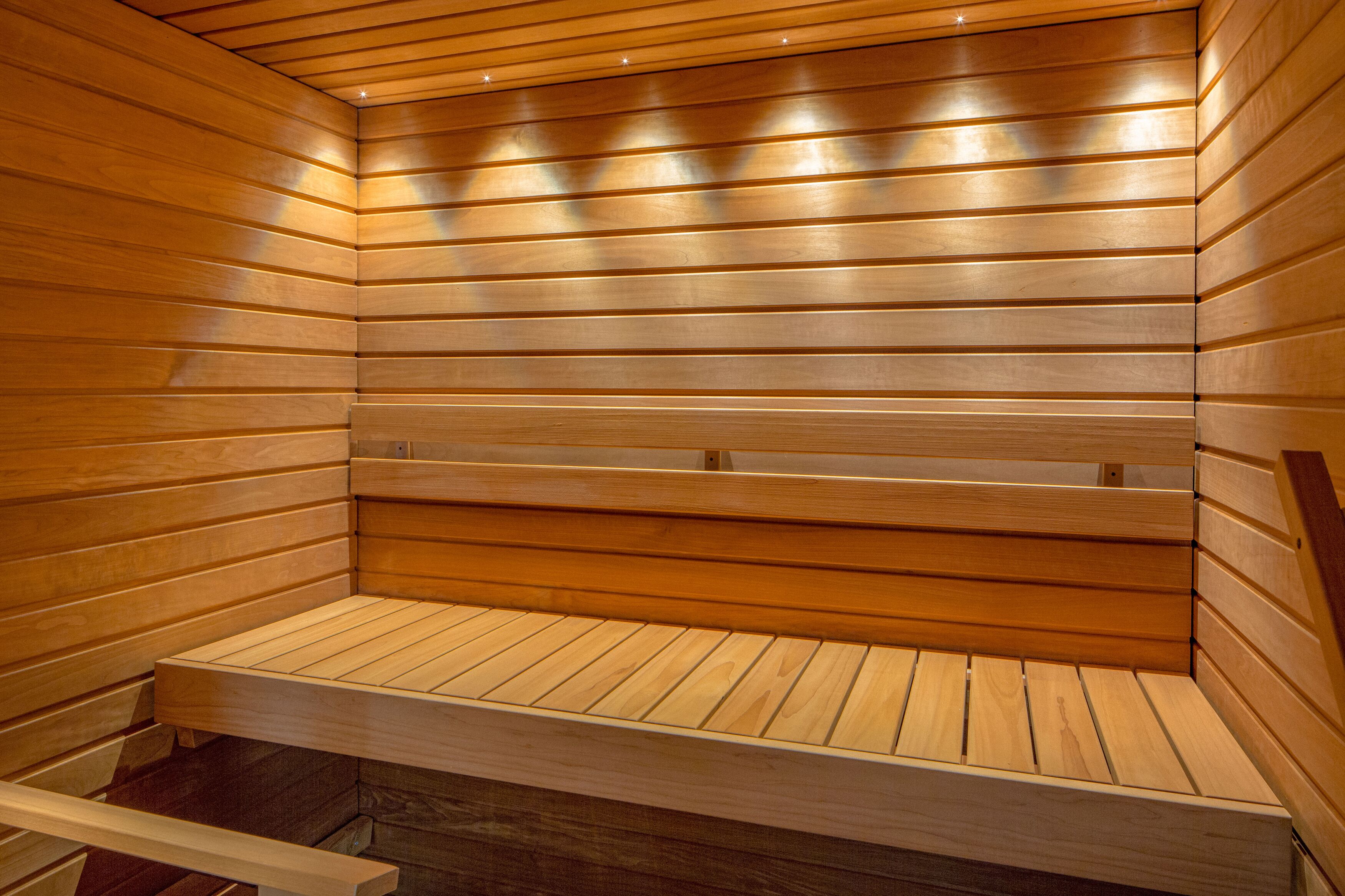 A sauna with wooden benches and slatted walls.